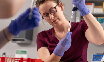 MLT student using a pipette