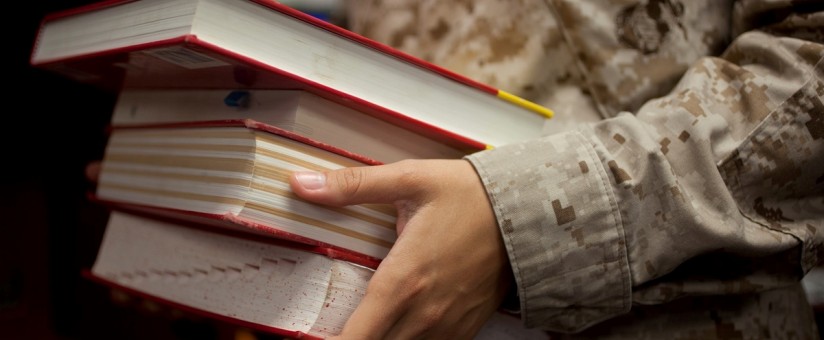 servicemember holding books